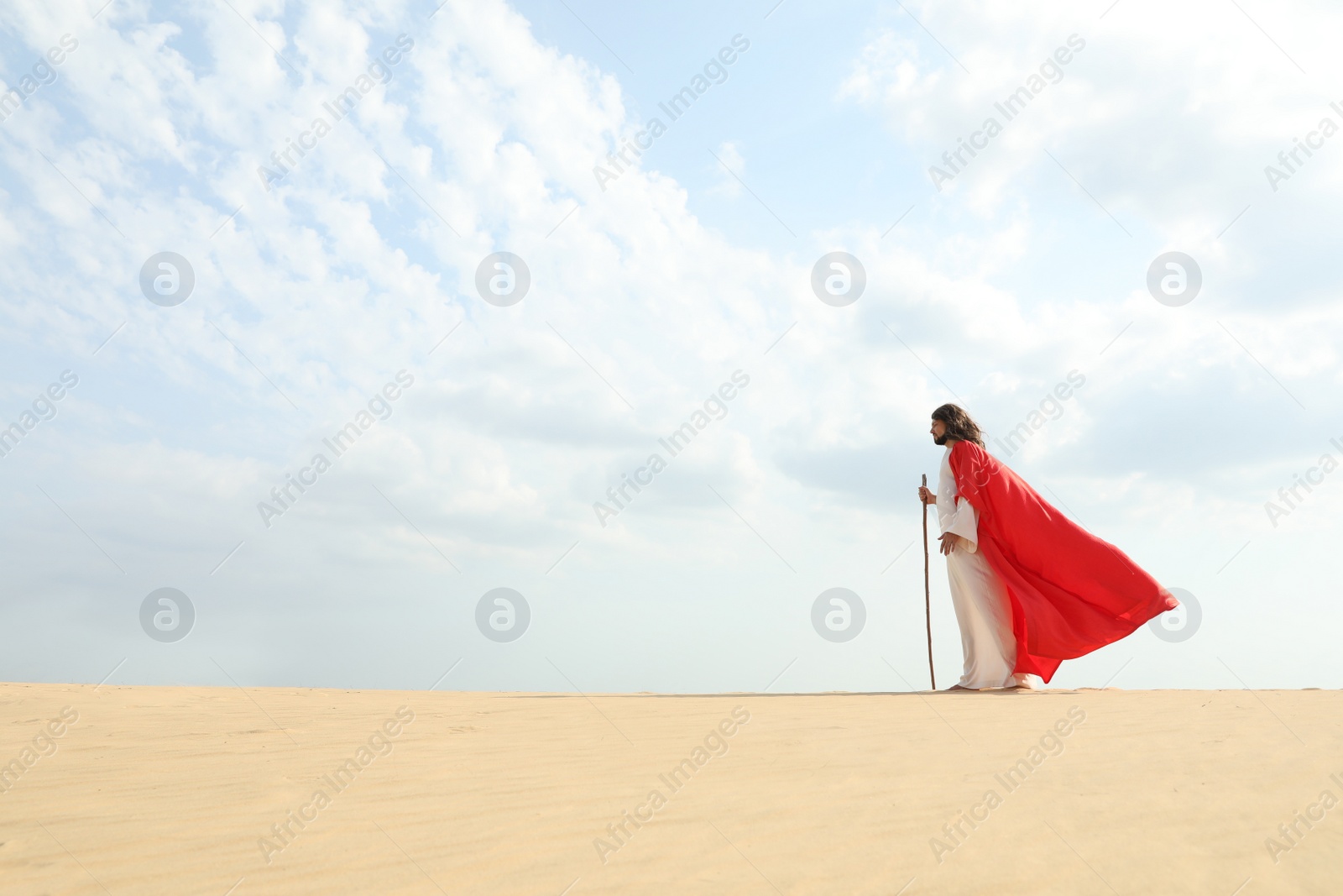 Jesus Christ walking with stick in desert. Space for text Photo of Jesus Christ walking with stick in desert. Space for text
