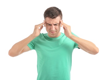 Young man suffering from headache on white background Photo of Young man suffering from headache on white background