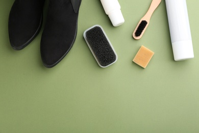 Stylish footwear with shoe care accessories on green background, flat lay. Space for text Photo of Stylish footwear with shoe care accessories on green background, flat lay. Space for text