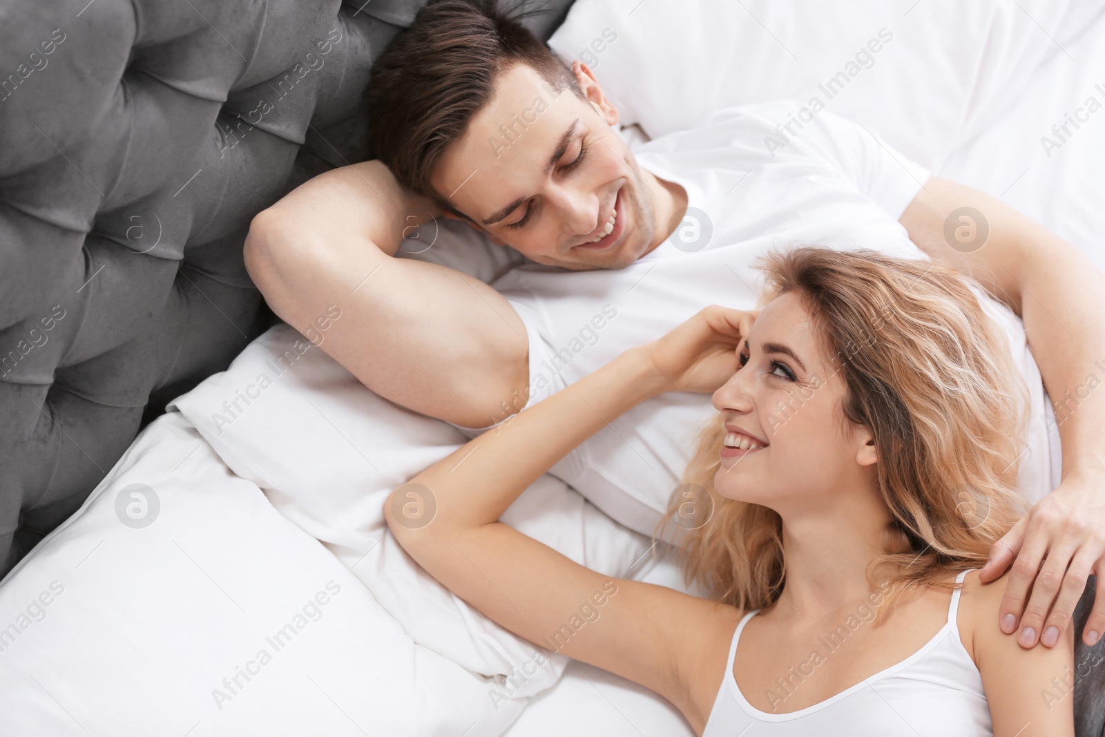 Lovely young couple lying in bed at home Photo of Lovely young couple lying in bed at home