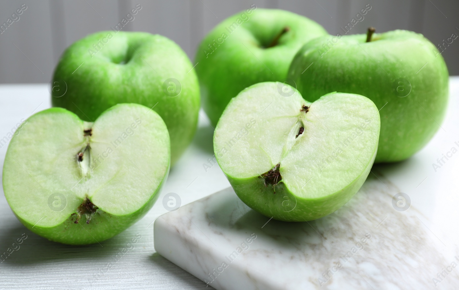 Fresh green apples on light table Photo of Fresh green apples on light table