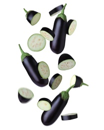 Cut and whole eggplants falling on white background Image of Cut and whole eggplants falling on white background
