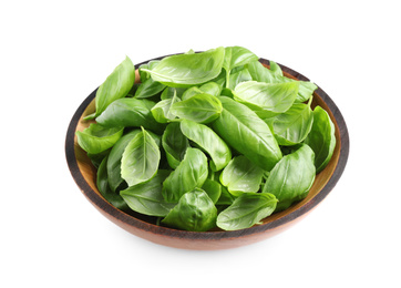 Fresh basil leaves in wooden bowl isolated on white Photo of Fresh basil leaves in wooden bowl isolated on white
