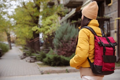 Female tourist with travel backpack on city street. Urban trip Photo of Female tourist with travel backpack on city street. Urban trip