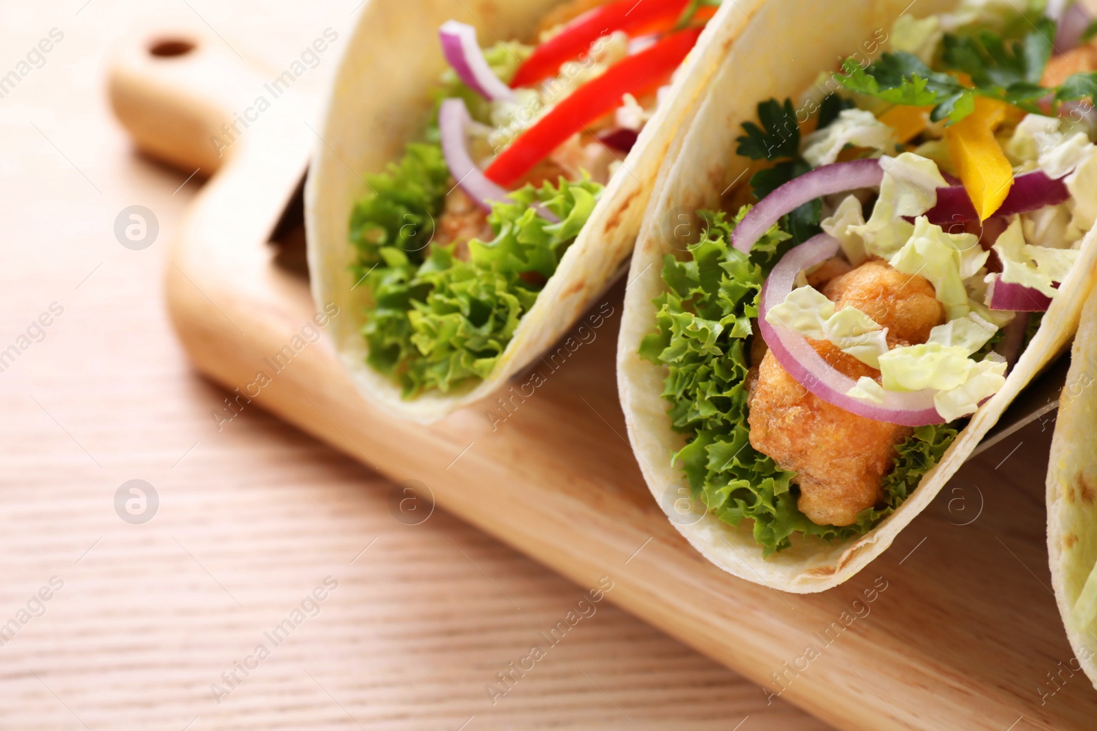 Delicious fish tacos served on wooden table, closeup Photo of Delicious fish tacos served on wooden table, closeup