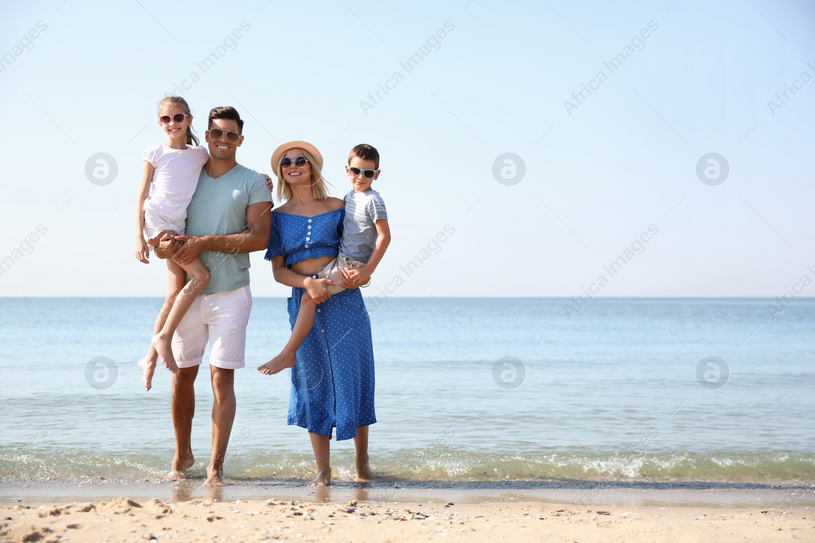 Happy family at beach on sunny summer day Photo of Happy family at beach on sunny summer day