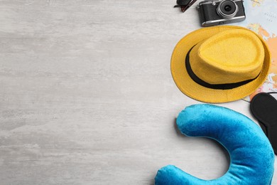 Image of Flat lay composition with blue travel pillow on light background, space for text