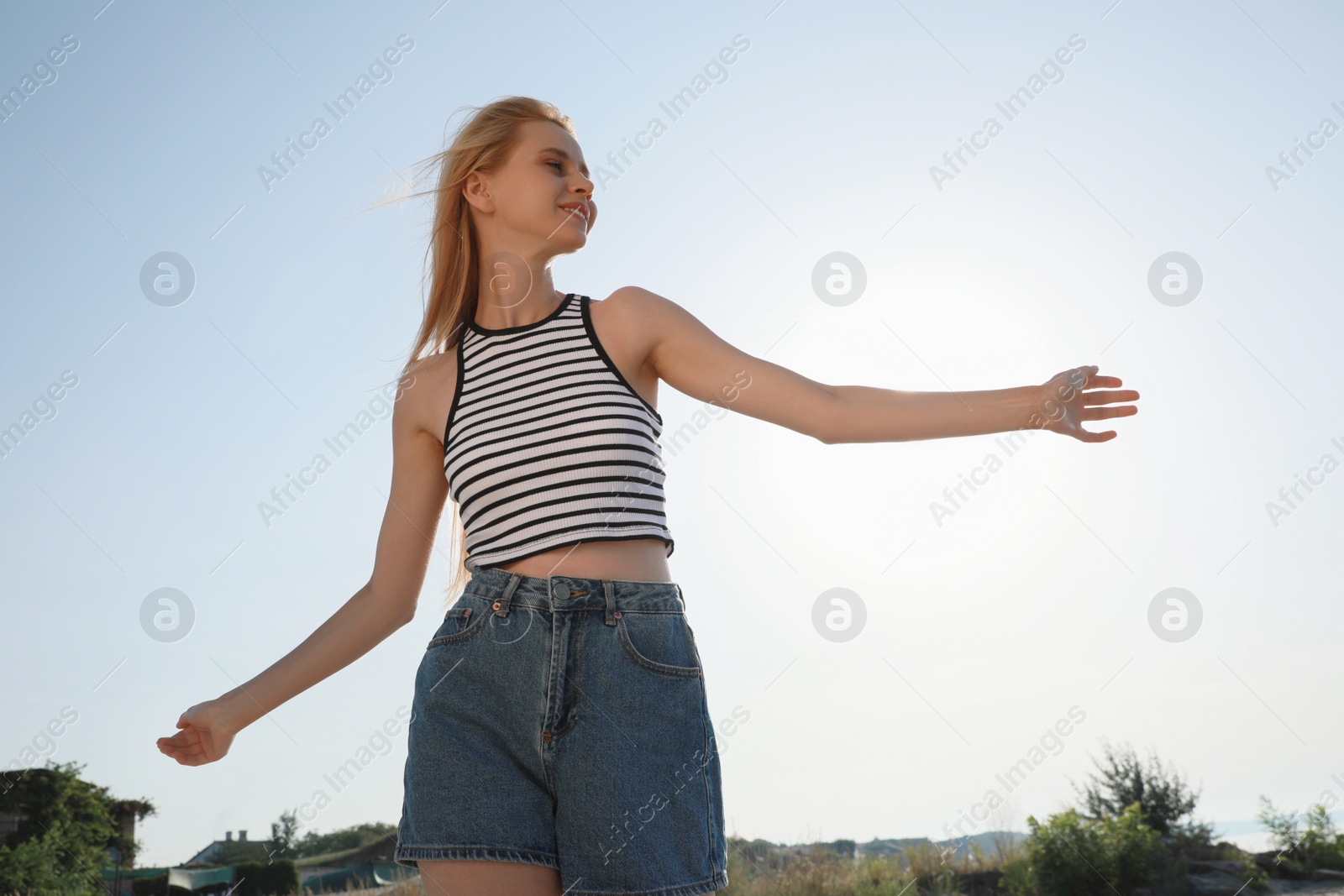 Beautiful young woman outdoors on sunny day Photo of Beautiful young woman outdoors on sunny day