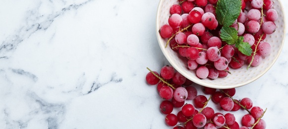 Tasty frozen red currants on white marble table, flat lay. Space for text Photo of Tasty frozen red currants on white marble table, flat lay. Space for text