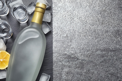 Cold Russian vodka on grey table, flat lay. Space for text Photo of Cold Russian vodka on grey table, flat lay. Space for text