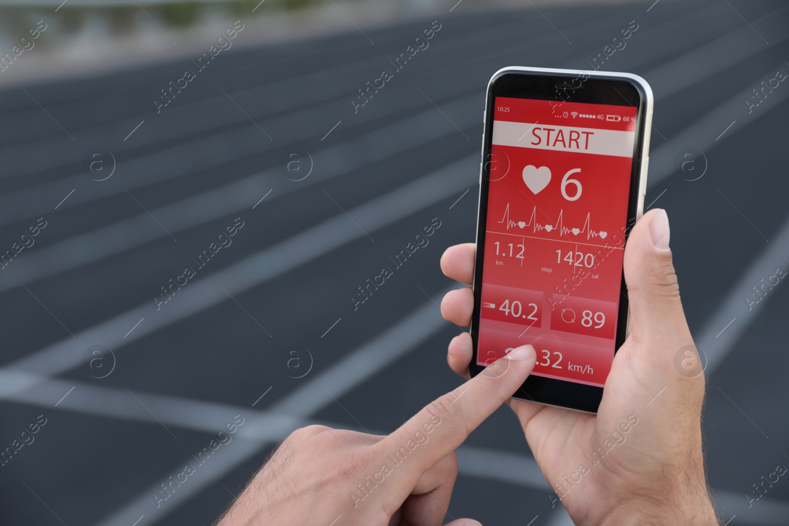 Man using fitness app on smartphone at stadium, closeup Photo of Man using fitness app on smartphone at stadium, closeup
