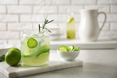 Jar with fresh lemonade and ingredients on table Photo of Jar with fresh lemonade and ingredients on table