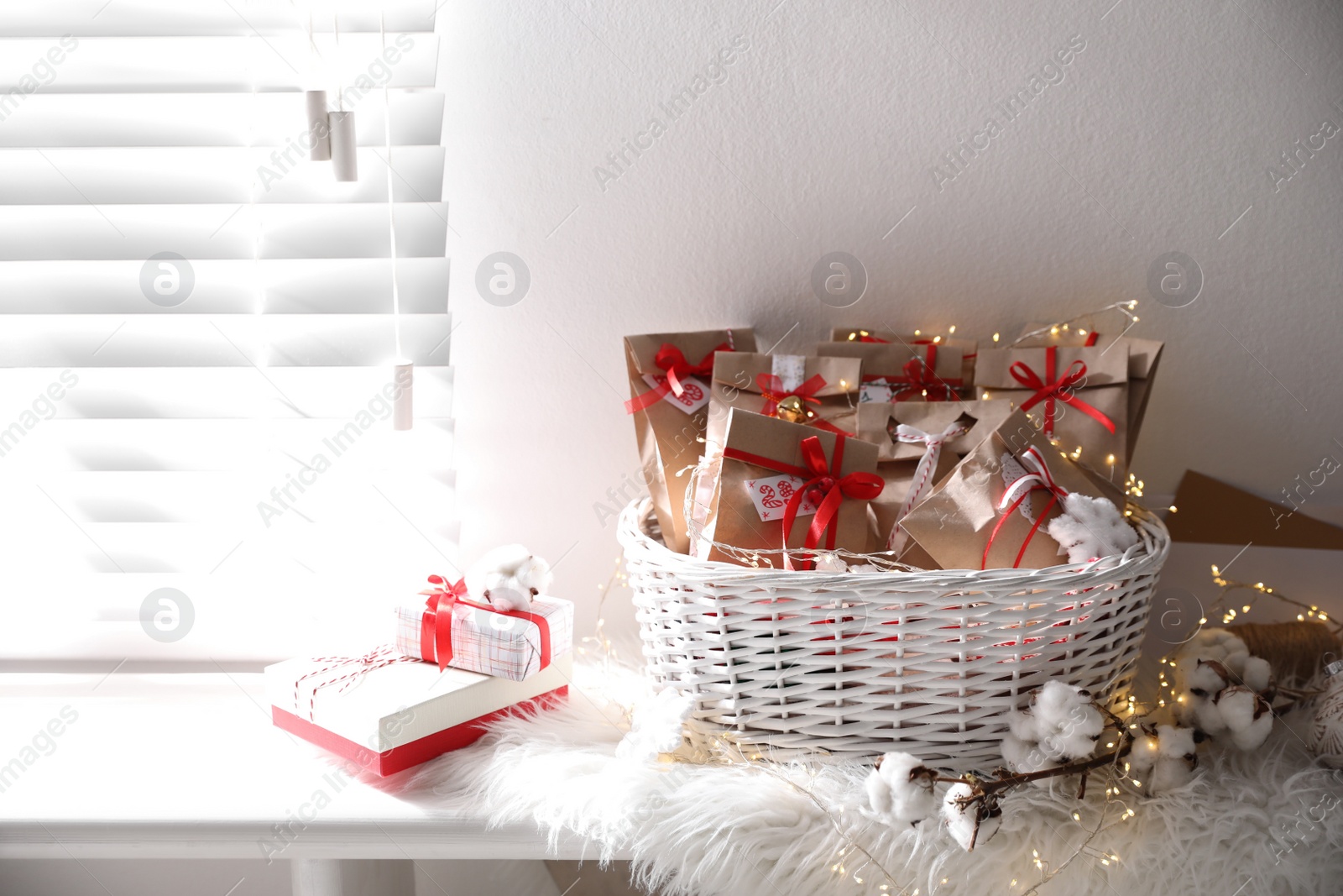 Set of gifts in basket and Christmas decor on window sill indoors. Advent calendar Photo of Set of gifts in basket and Christmas decor on window sill indoors. Advent calendar