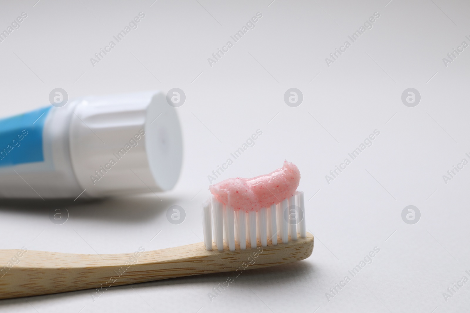 Brush with toothpaste and tube on white background, closeup Photo of Brush with toothpaste and tube on white background, closeup