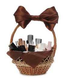 Cosmetic gift set in wicker basket isolated on white Photo of Cosmetic gift set in wicker basket isolated on white