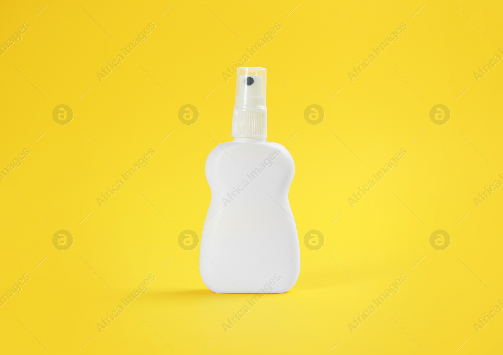 Bottle with insect repellent spray on yellow background Photo of Bottle with insect repellent spray on yellow background
