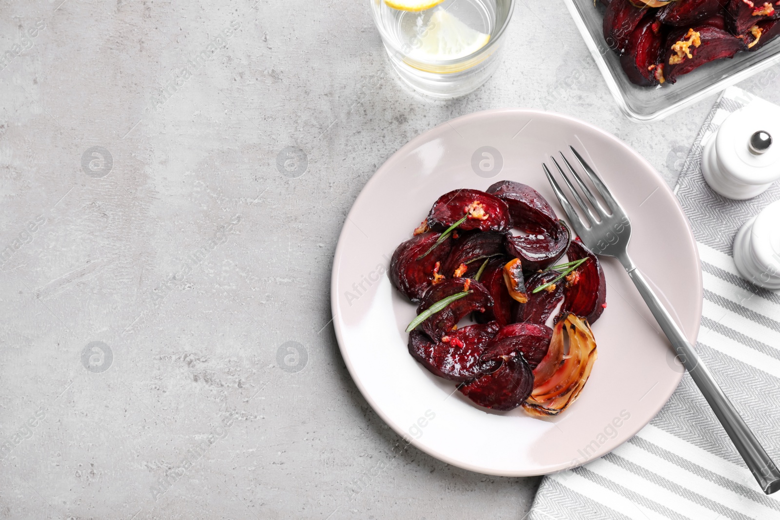 Roasted beetroot slices served on light grey table, flat lay. Space for text Photo of Roasted beetroot slices served on light grey table, flat lay. Space for text