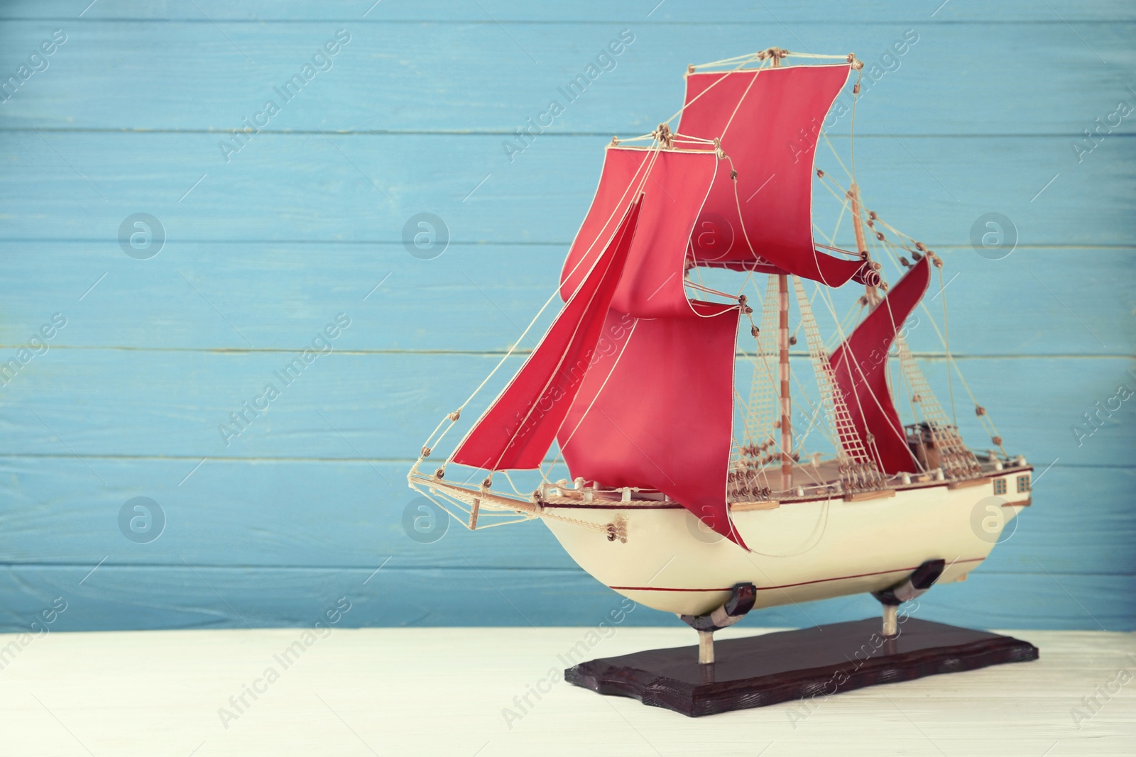 Beautiful ship model on white wooden table. Space for text Photo of Beautiful ship model on white wooden table. Space for text
