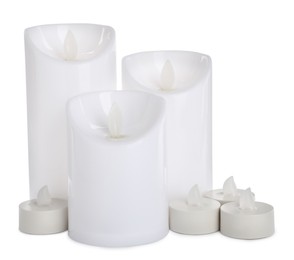 Different decorative flameless LED candles on white background Photo of Different decorative flameless LED candles on white background