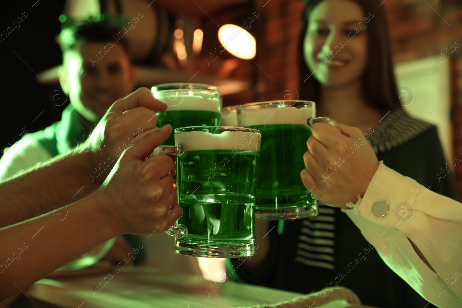 Photo of People with beer celebrating St Patrick's day in pub, closeup