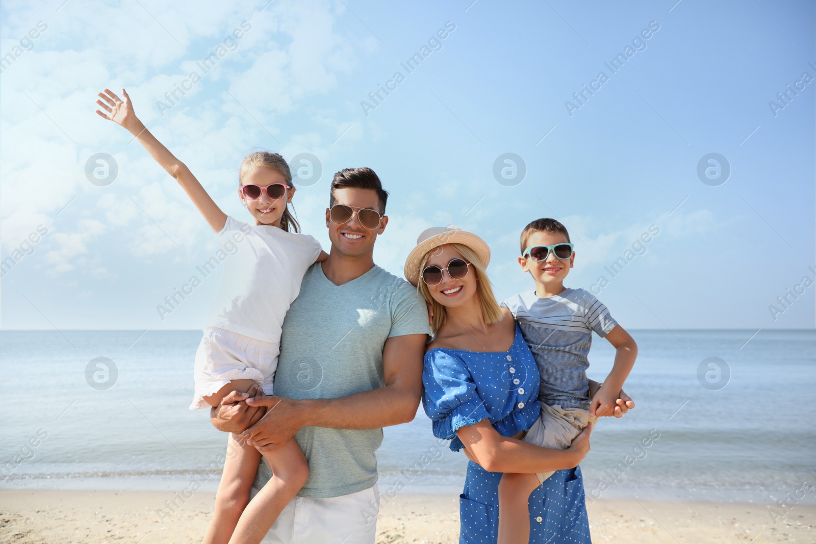 Happy family at beach on sunny summer day Photo of Happy family at beach on sunny summer day