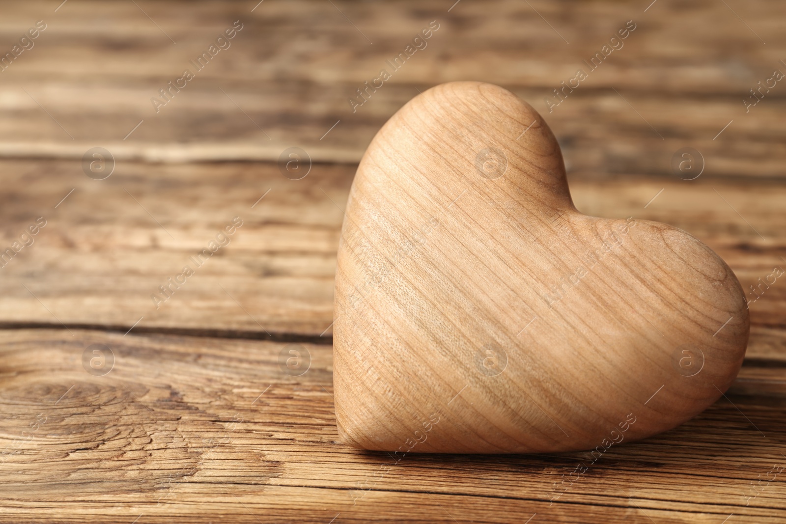 Decorative heart on wooden table, closeup. Valentine's Day Photo of Decorative heart on wooden table, closeup. Valentine's Day