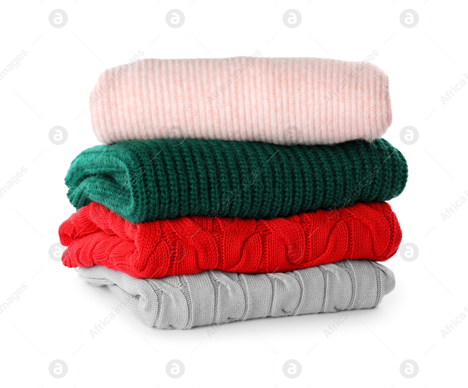 Stack of different warm sweaters isolated on white Photo of Stack of different warm sweaters isolated on white