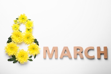 8 March greeting card design with chrysanthemum flowers and wooden letters on white background, top view. International Women's day Photo of 8 March greeting card design with chrysanthemum flowers and wooden letters on white background, top view. International Women's day