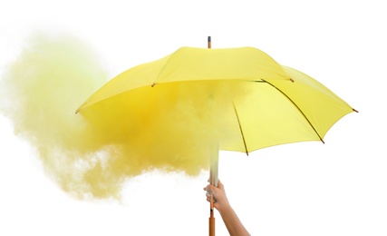 Woman holding umbrella with yellow smoke bomb outdoors, closeup Photo of Woman holding umbrella with yellow smoke bomb outdoors, closeup