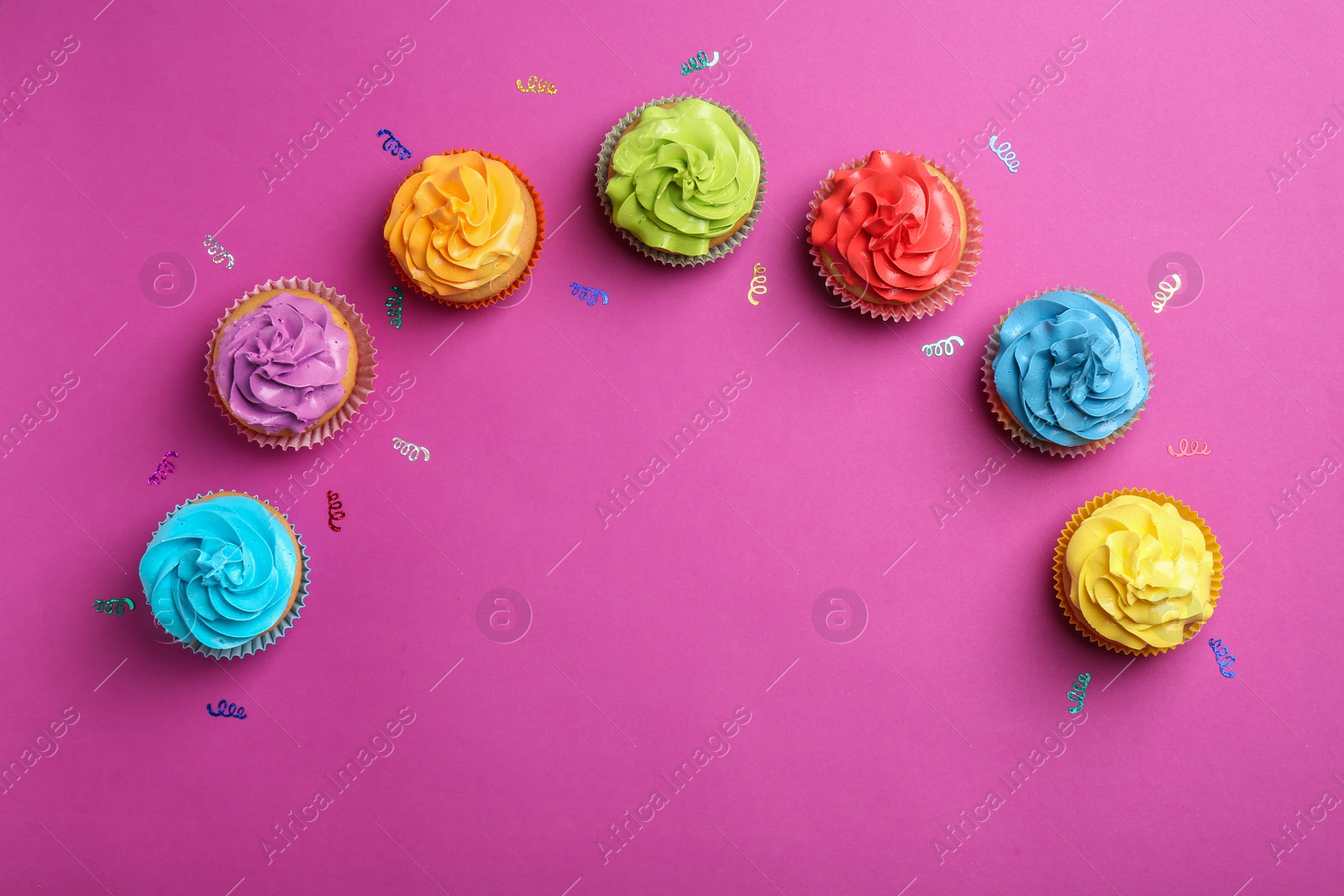 Delicious birthday cupcakes on color background Photo of Delicious birthday cupcakes on color background