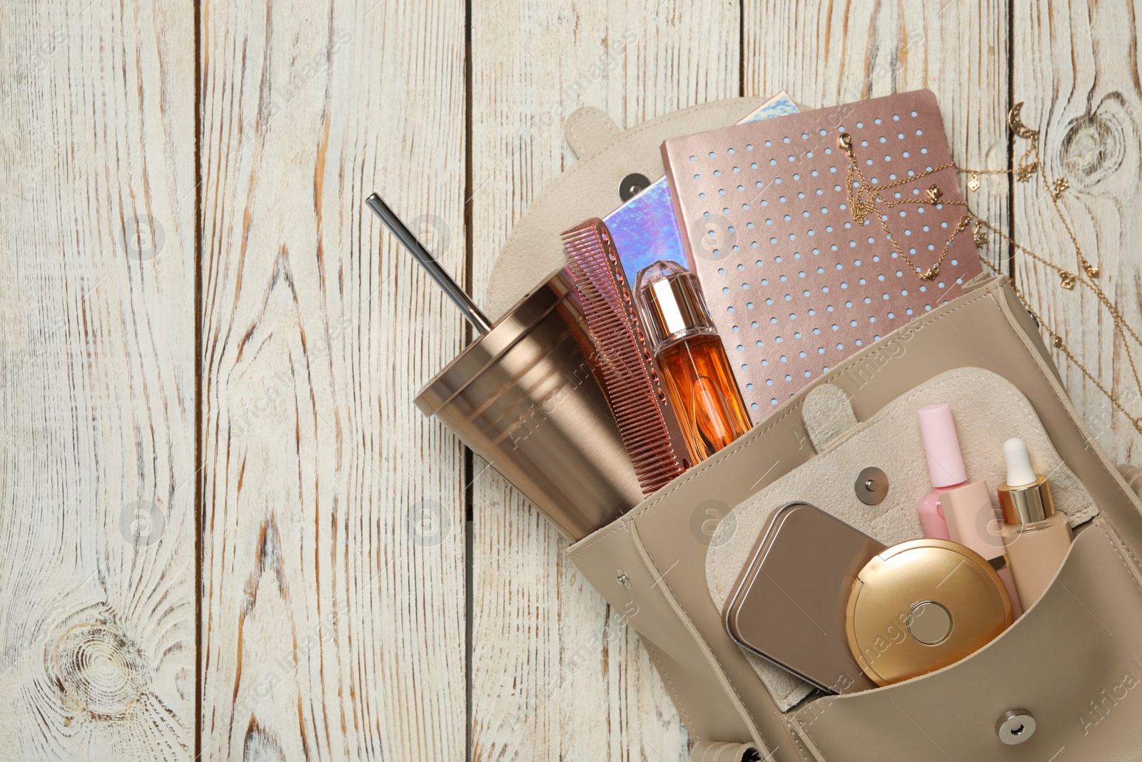 Stylish urban backpack with different items on white wooden background, flat lay. Space for text Photo of Stylish urban backpack with different items on white wooden background, flat lay. Space for text