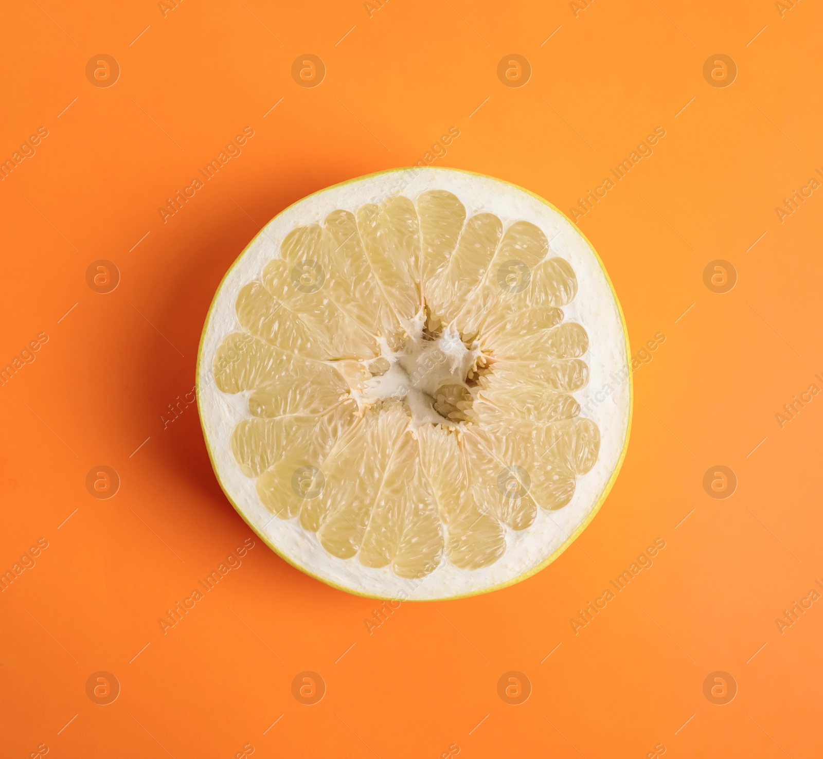 Fresh cut pomelo fruit on orange background, top view Photo of Fresh cut pomelo fruit on orange background, top view