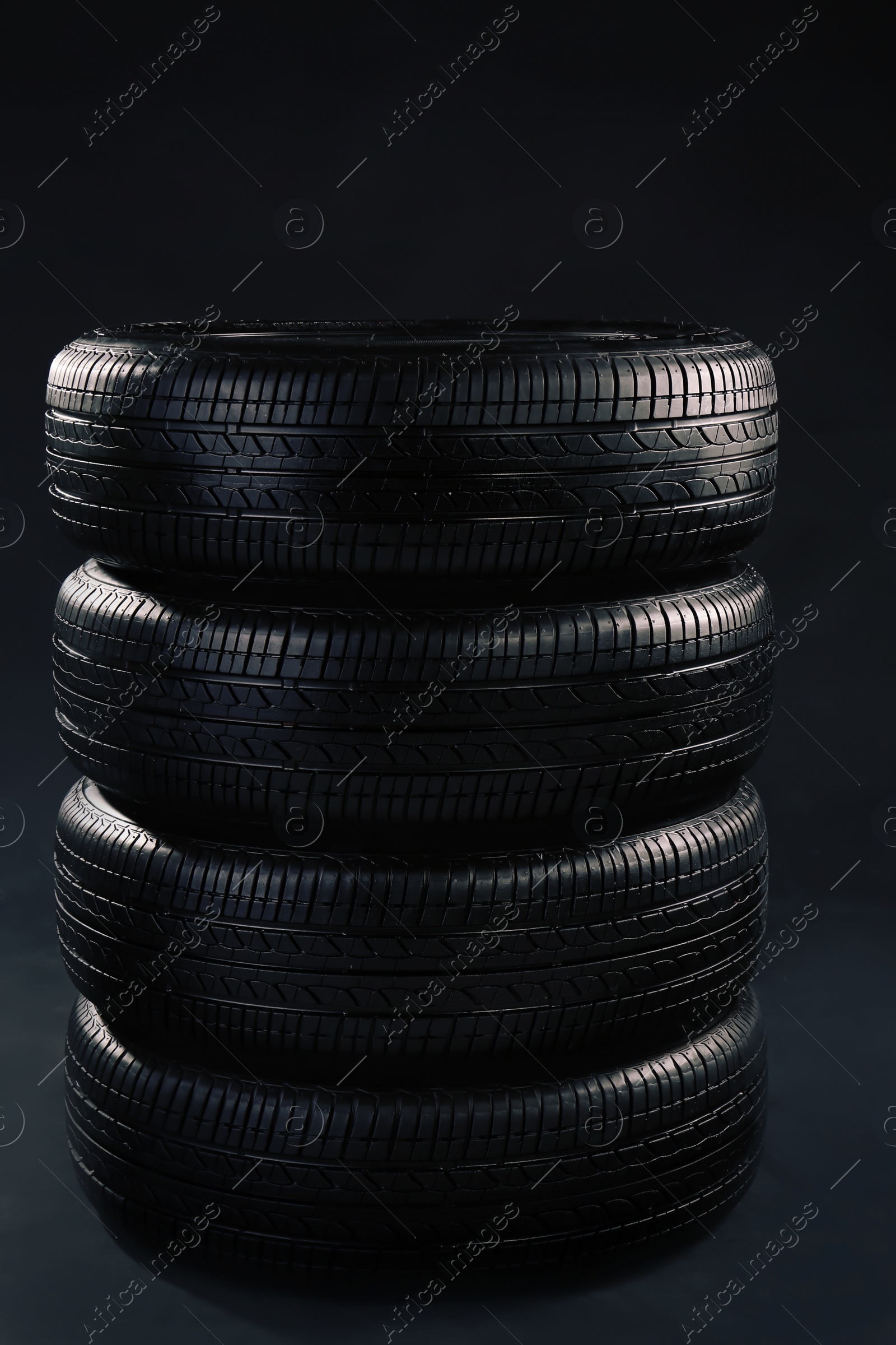 Car tires on grey background Photo of Car tires on grey background