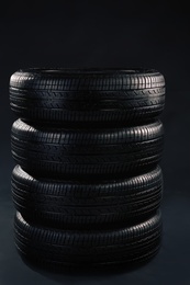 Car tires on grey background Photo of Car tires on grey background