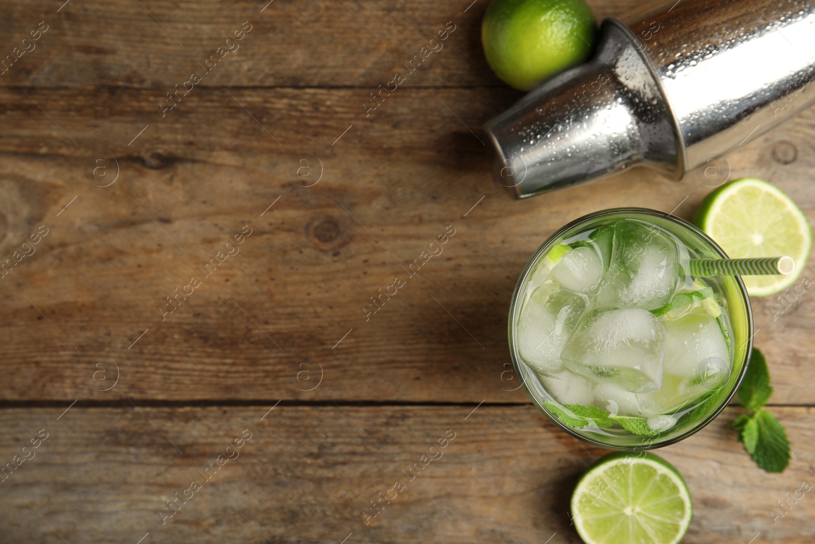 Delicious mojito and ingredients on wooden table, flat lay. Space for text Photo of Delicious mojito and ingredients on wooden table, flat lay. Space for text