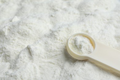 Powdered infant formula and scoop, closeup with space for text. Baby milk Photo of Powdered infant formula and scoop, closeup with space for text. Baby milk