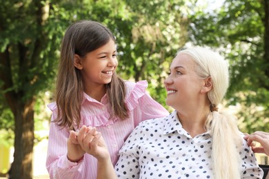 Mature woman with her little granddaughter in park Photo of Mature woman with her little granddaughter in park