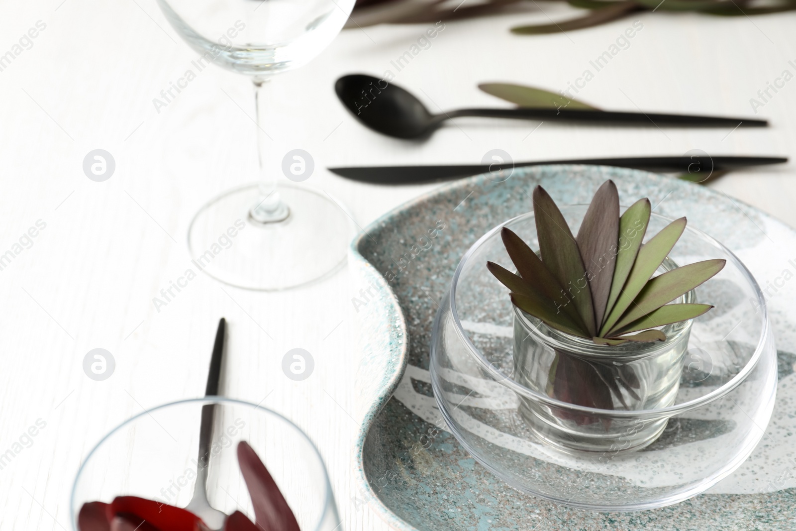 Elegant table setting with floral decor on white wooden background Photo of Elegant table setting with floral decor on white wooden background