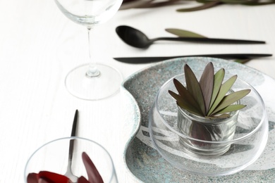 Elegant table setting with floral decor on white wooden background Photo of Elegant table setting with floral decor on white wooden background