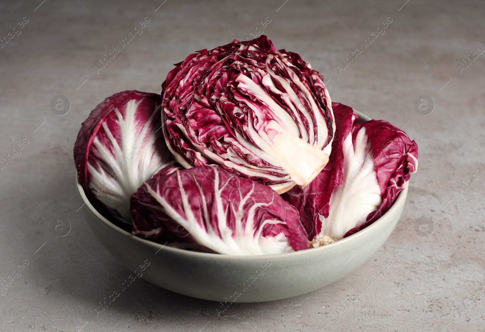Photo of Whole fresh ripe radicchios on grey table