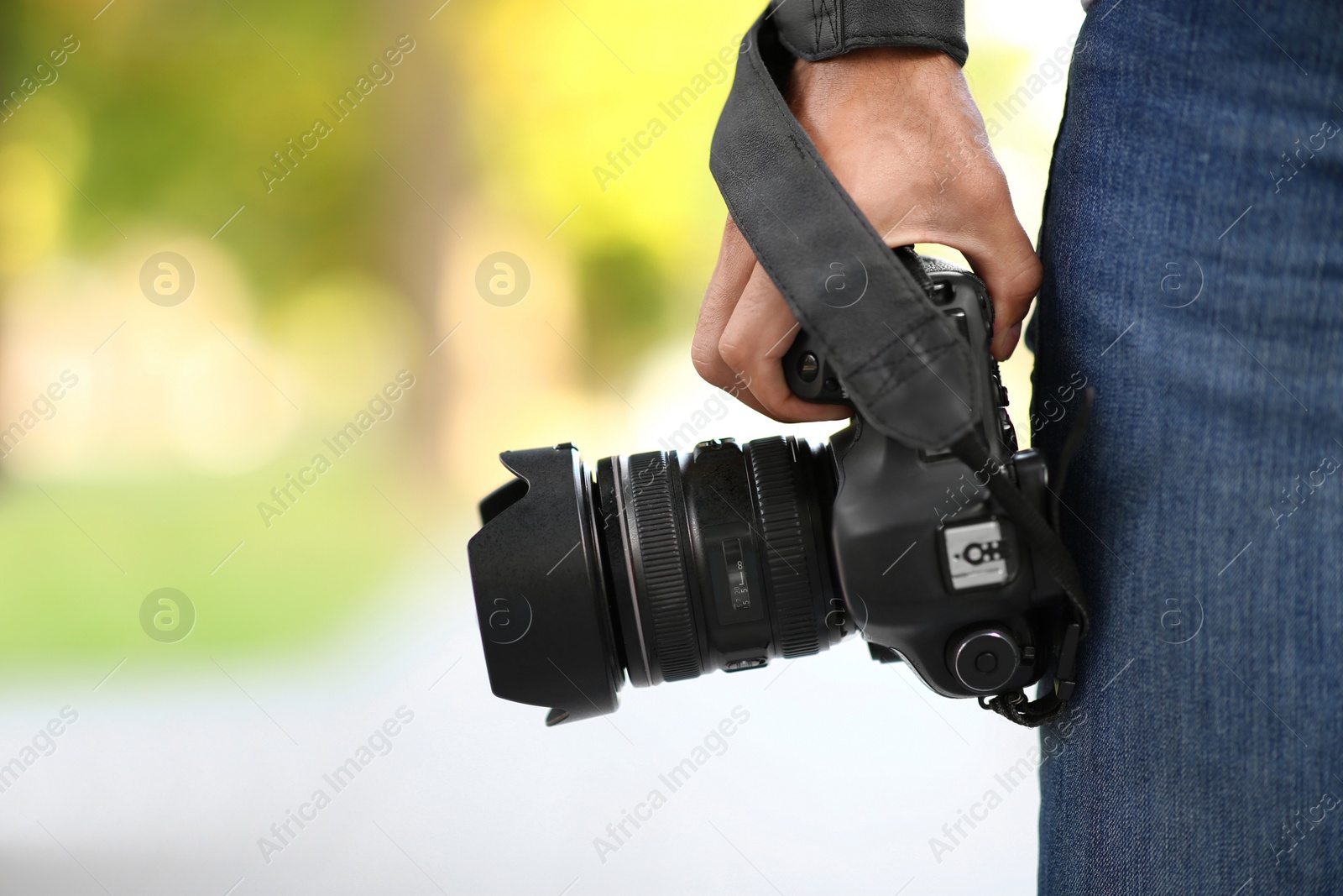 Photographer with professional camera outdoors, closeup view Photo of Photographer with professional camera outdoors, closeup view