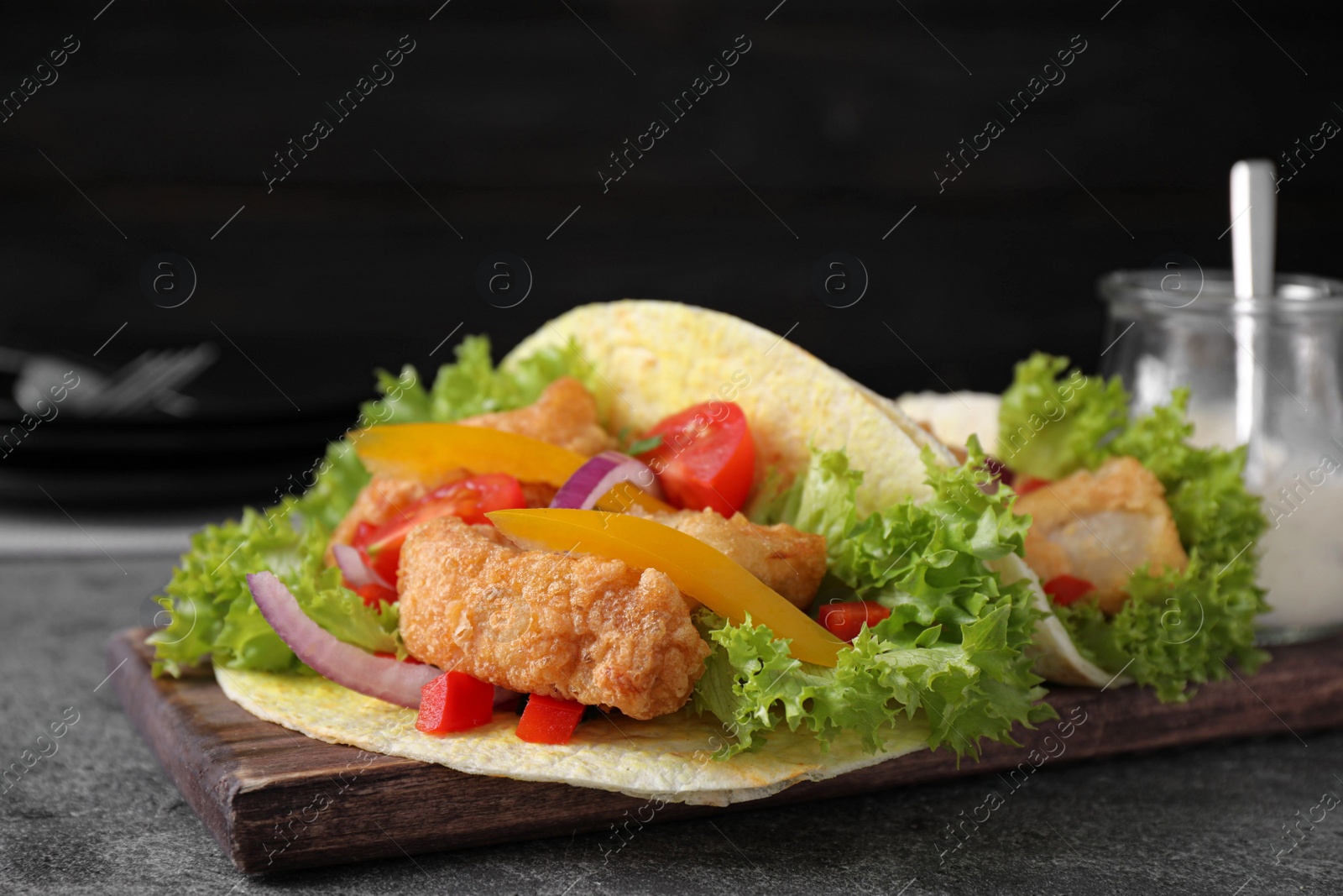 Delicious fish tacos served on grey table, closeup Photo of Delicious fish tacos served on grey table, closeup