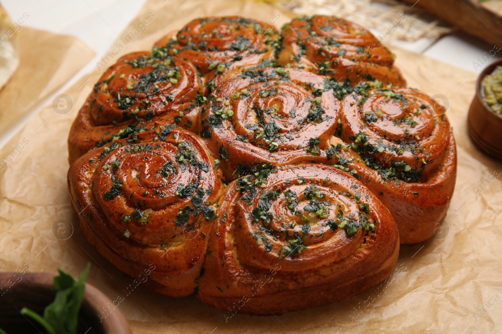 Traditional pampushka rolls with garlic and herbs on table, closeup Photo of Traditional pampushka rolls with garlic and herbs on table, closeup