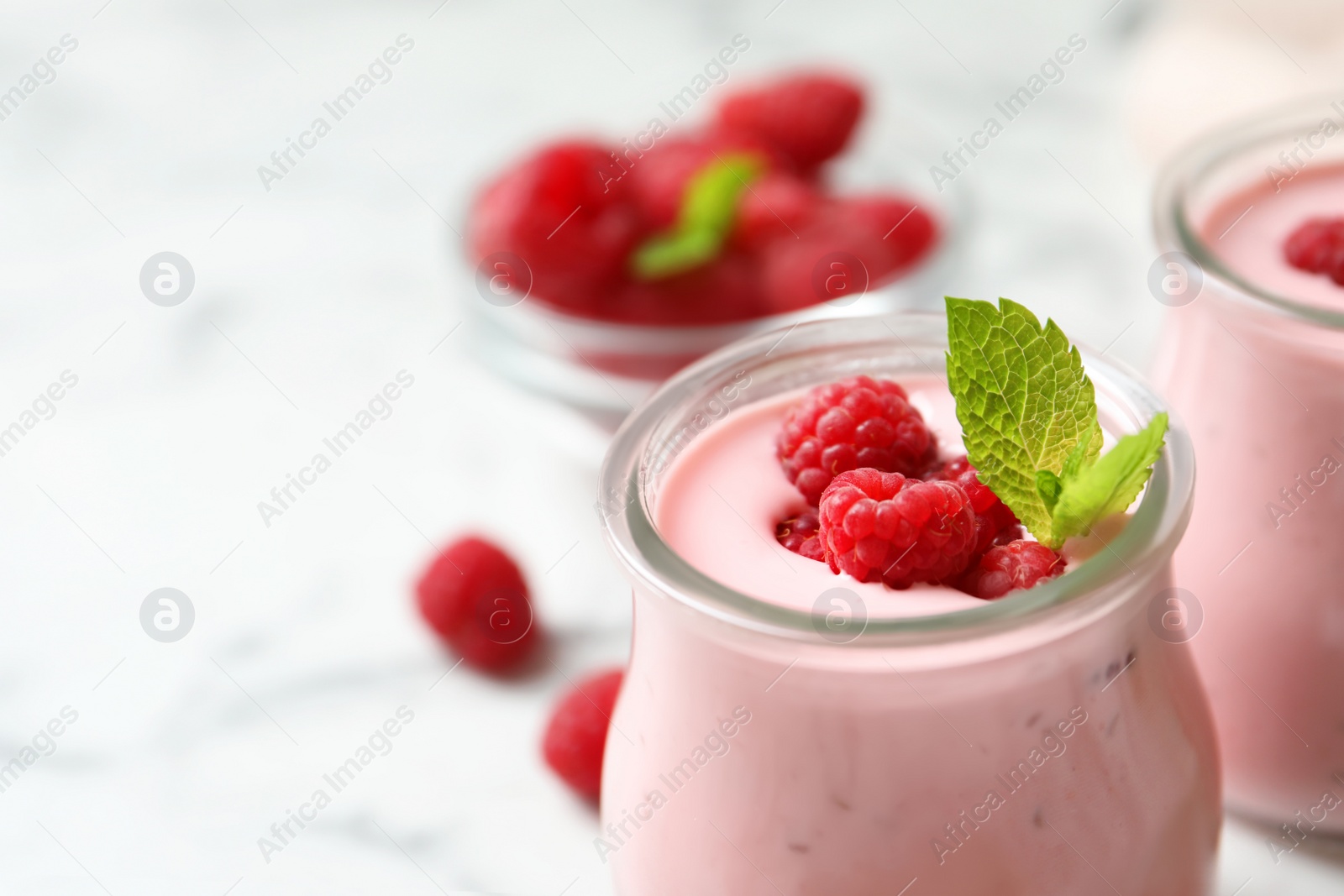 Yummy raspberry smoothie in glass jar on table, closeup Image of Yummy raspberry smoothie in glass jar on table, closeup