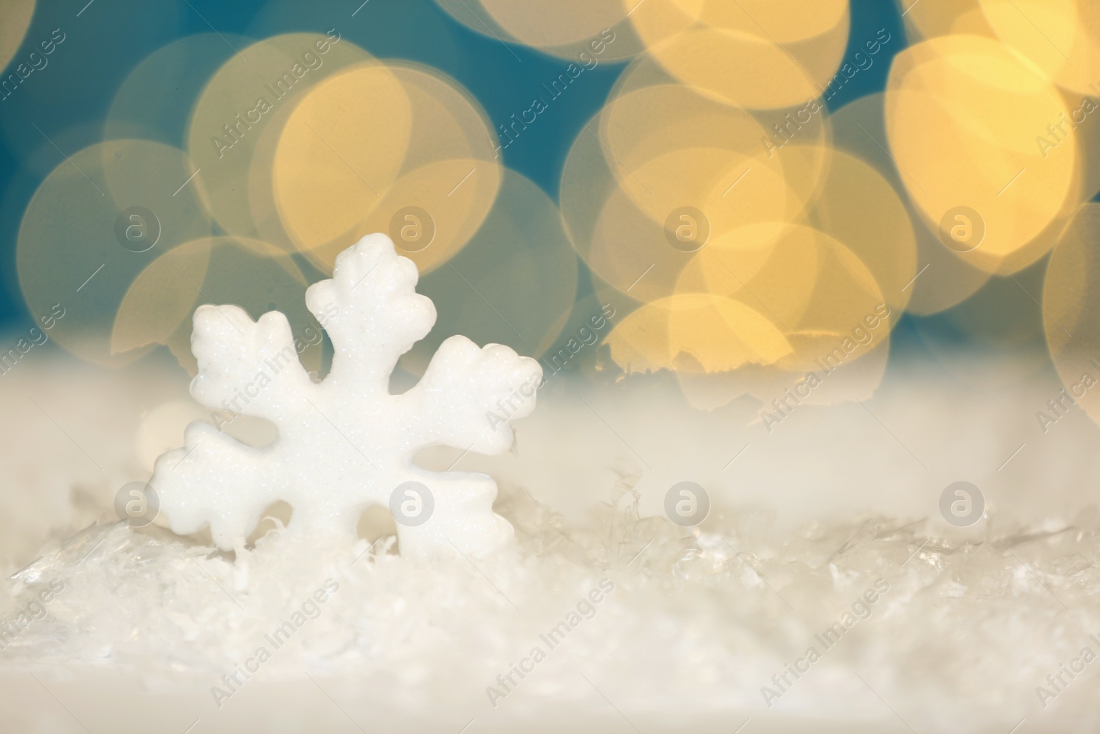 Beautiful decorative snowflake against blurred festive lights, space for text Photo of Beautiful decorative snowflake against blurred festive lights, space for text