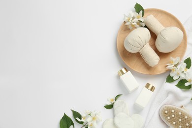 Flat lay composition with spa stones and jasmine flowers on white background, space for text Photo of Flat lay composition with spa stones and jasmine flowers on white background, space for text