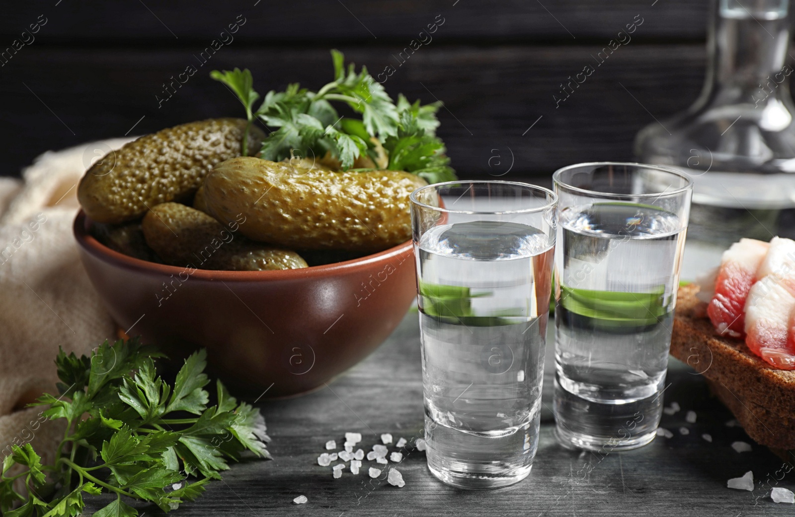 Cold Russian vodka with snacks on wooden table Photo of Cold Russian vodka with snacks on wooden table