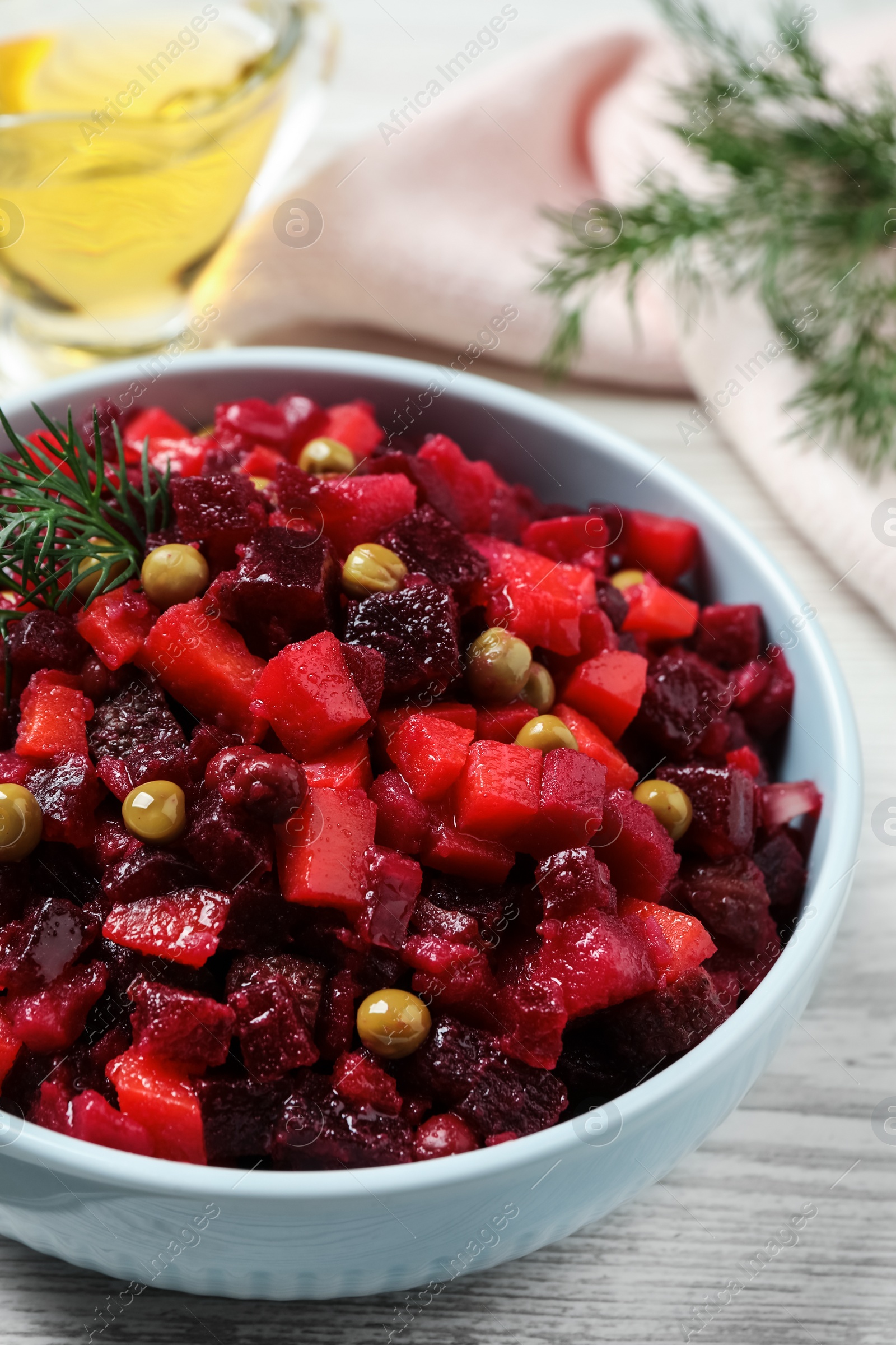 Traditional Russian vinaigrette salad on white wooden table, closeup Photo of Traditional Russian vinaigrette salad on white wooden table, closeup