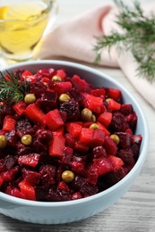 Traditional Russian vinaigrette salad on white wooden table, closeup Photo of Traditional Russian vinaigrette salad on white wooden table, closeup