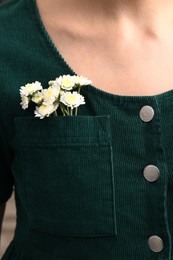 Woman wearing shirt with flowers in pocket, closeup Photo of Woman wearing shirt with flowers in pocket, closeup
